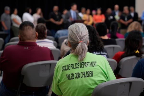 Families of the victims in the Uvalde elementary school shooting listen to attorney Josh Koskoff during a news conference, Wednesday, May 22, 2024, in Uvalde, Texas. The families of 19 of the victims announced a lawsuit against nearly 100 state police officers who were part of the botched law enforcement response. The families say they also agreed a $2 million settlement with the city, under which city leaders promised higher standards and better training for local police. (AP Photo/Eric Gay)