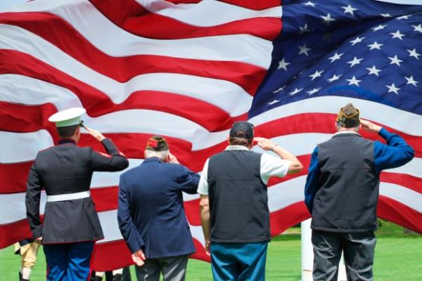 Veterans saluting the flag.