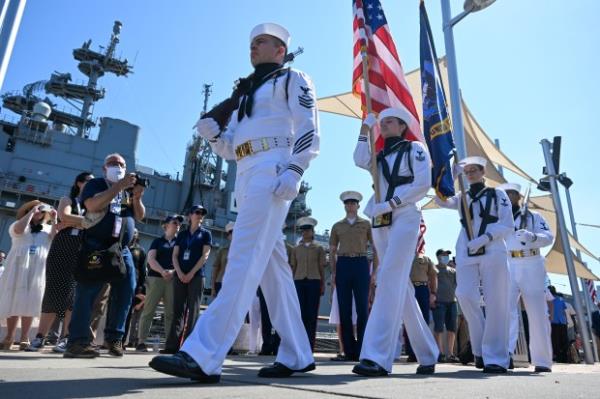 US Navy sailors walk in with the colors during the Intrepid Sea, Air & Space Museum's annual Memorial Day Commemoration Ceremony on May 31, 2022 in New York City.