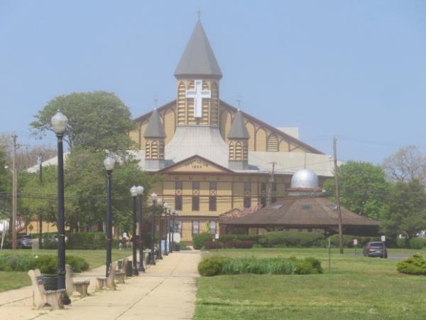 Haze slowly burns away from the Great Auditorium in Ocean Grove, N.J. on May 2, 2024. The state of New Jersey says the Ocean Grove Camp Meeting Association is violating state beach access laws by keeping people off the beach until noon on Sundays.