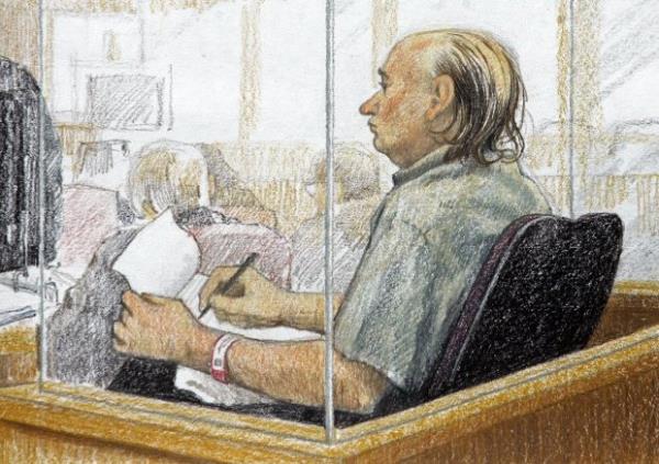 This artist's sketch shows accused serial killer Robert Pickton taking notes during the second day of his trial in B.C. Supreme Court in New Westminster, British Columbia, Jan. 31, 2006. Co<em></em>nvicted Canadian serial killer Pickton has been hospitalized and is in a life-threatening co<em></em>ndition after an assault at a Quebec prison, authorities said Tuesday, May 21, 2024. (Jane Wolsack/The Canadian Press via AP)