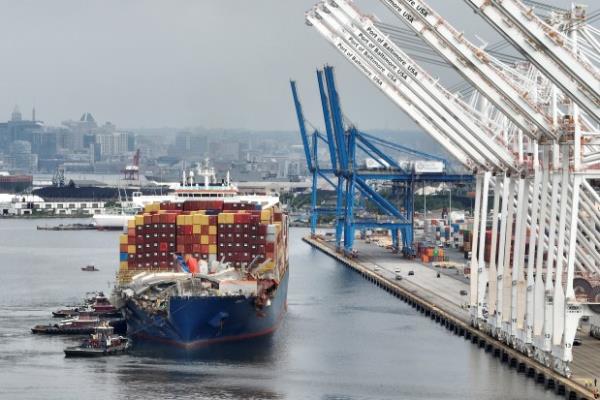 BALTIMORE, MARYLAND - MAY 20: In this aerial view, the damaged co<em></em>ntainer ship Dali is maneuvered into the Seagirt Marine Terminal on May 20, 2024 in Baltimore, Maryland. On March 26th the Dali crashed into the Francis Scott Key Bridge, causing it to collapse killing six co<em></em>nstruction workers, and closing the Patapsco River and the Port of Baltimore for weeks. (Photo by Chip Somodevilla/Getty Images)