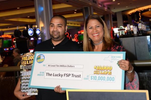 Yolanda Vega, right, presents a prize check to Imran Mohammed at Resorts World Casino on Tuesday, November 28, 2017 in Queens, New York. (Debbie Egan-Chin/New York Daily News)