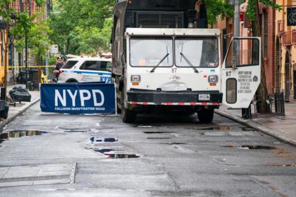 An unidentified adult male was pro<em></em>nounced dead on scene after he was run over while standing on Cornelia Street by a 35yr old man who was driving a Liberty Ashes garbage truck in reverse down the one-way Cornelia Street from West 4th Street in Manhattan on Thursday May 16, 2024. 0909. (Theodore Parisienne for New York Daily News)