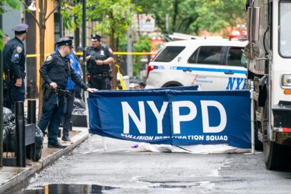 An unidentified adult male was pro<em></em>nounced dead on scene after he was run over while standing on Cornelia Street by a 35yr old man who was driving a Liberty Ashes garbage truck in reverse down the one-way Cornelia Street from West 4th Street in Manhattan on Thursday May 16, 2024. 0909. (Theodore Parisienne for New York Daily News)