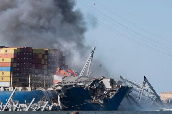 Explosive charges are deto<em></em>nated to bring down sections of the collapsed Francis Scott Key Bridge resting on the co<em></em>ntainer ship Dali on Monday, May 13, 2024, in Baltimore. (AP Photo/Mark Schiefelbein)