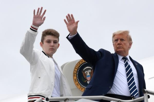 In this Aug. 16, 2020 file photo, President Do<em></em>nald Trump, right, and his son Barron Trump wave from the top of the steps to Air Force One at Morristown Municipal Airport in Morristown, N.J. (Susan Walsh/AP)