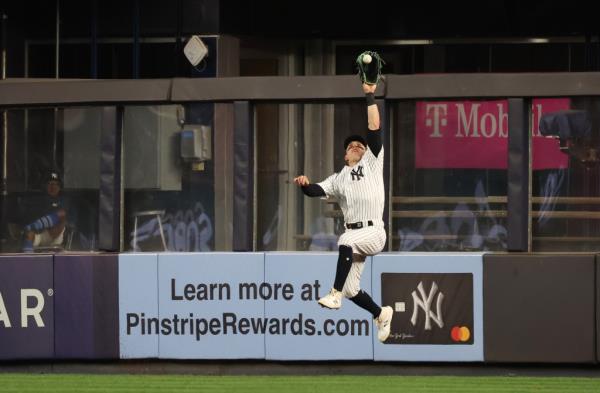 Yankees center fielder Harrison Bader (22) leaps and catches a line drive