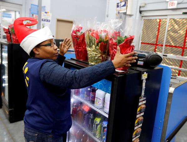 An employee checks on a Christmas display at a Walmart store in Chicago