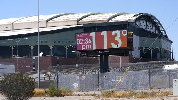 With Chase Field, home of the Arizona Diamo<em></em>ndbacks ba<em></em>seball team in the background, a digital billboard updates the time and temperature as temperatures are expected to hit 116-degrees July 18, 2023, in Phoenix.