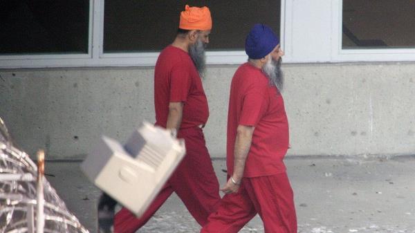 Accused Air India bombers Ajaib Singh Bagri (R) and Ripudaman Singh Malik walk together through the exercise yard at the jail wher<em></em>e they are in custody November 1, 2004 in Vancouver, British Columbia, Canada.