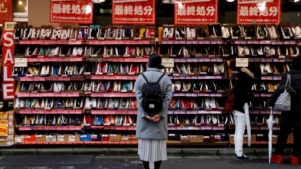  A woman looks at shoes on sale at an outlet store in Tokyo's shopping district, Japan, December 1, 2016. REUTERS/Toru Hanai