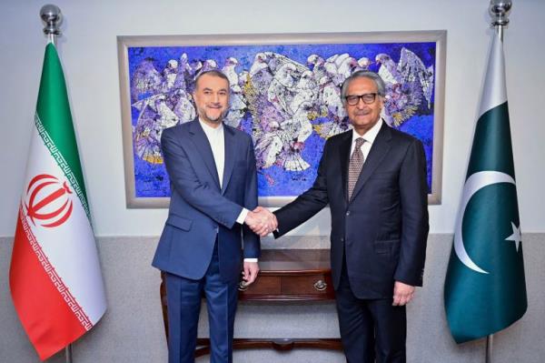 In this photo released by Pakistan's Ministry of Foreign Affairs, visiting Iran's Foreign Minister Hossein Amirabdollahian, left, shakes hands with his Pakistani counterpart Jalil Abbas Jilani