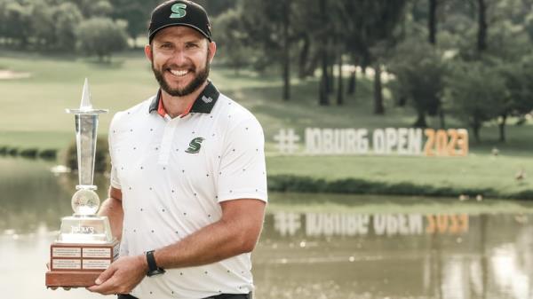 Dean Burmester of South Africa poses with the trophy