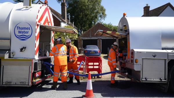 A tanker from Thames Water pumps water into another tanker in the village of Northend in Oxfordshire, 