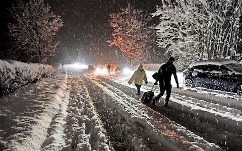 Visitors to the Lake District hauling suitcases through thick snow at the weekend after cars became stranded