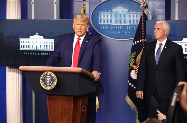 President Do<em></em>nald Trump speaks as Vice President Mike Pence stands behind him at the White House press briefing room on Nov. 24, 2020. A mo<em></em>nth later, Pence reportedly wrote that he should abdicate his role in overseeing the Electoral College count.