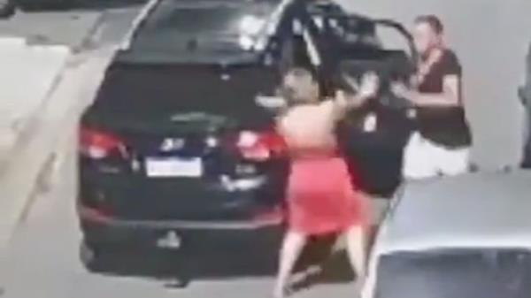 Other parts of the surveillance footage showed the woman struggling to get the man out of the vehicle before he exited on his own and launched at her, punching her multiple times. 