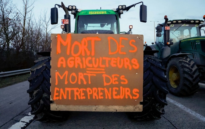 A tractor with a placard bearing the slogan 