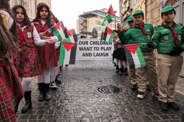 Palestinian scouts joined the silent procession in Bethlehem holding banners that called for peace in Gaza.