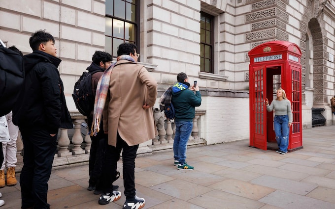 Tourists queue at the phone boxes in Parliament Square. For Choppera  s Peterborough column. Jamie Lorriman