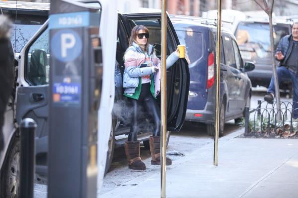 Hilaria Baldwin opening car door wearing blue jacket and sunglasses for morning school run.