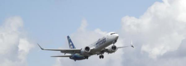 FILE - An Alaska Airlines Boeing 737-9 Max flies above Paine Field near Boeing's manufacturing facility in Everett, Wash., Monday, March 23, 2020, north of Seattle. A window panel blew out on a similar Alaska Airlines Boeing 737-9 Max seven minutes after takeoff from Portland, Ore., on Friday, Jan. 5, 2023. (AP Photo/Ted S.