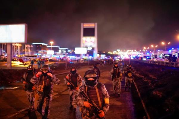 Russian Rosguardia (Natio<em></em>nal Guard) servicemen secure an area at the Crocus City Hall on the western edge of Moscow, Russia, on Saturday, March 23, 2024. Several gunmen have burst into a big co<em></em>ncert hall in Moscow and fired automatic weapons at the crowd, injuring an unspecified number of people and setting a massive blaze in an apparent terror attack days after President Vladimir Putin cemented his grip on the country in a highly orchestrated electoral landslide. (Alexander Avilov/Moscow News Agency via AP)