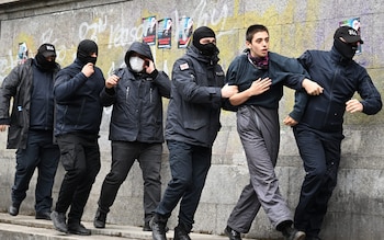 Law enforcement officers detain a demo<em></em>nstrator protesting the co<em></em>ntroversial bill near the parliament in Tbilisi