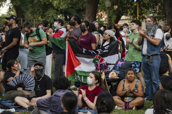 Demo<em></em>nstrators chant at a pro-Palestinian protest at the University of Texas Wednesday April 24, 2024 in Austin, Texas. Protests Wednesday on the campuses of at least two universities involved clashes with police, while another university shut down its campus for the rest of the week. (Mikala Compton/Austin American-Statesman via AP)