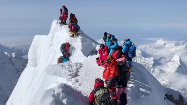 Two climbers hold on after a cornice collapsed on Hillary Step on Mount Everest on 21 May. Pic: Instagram / @malla.mountaineer