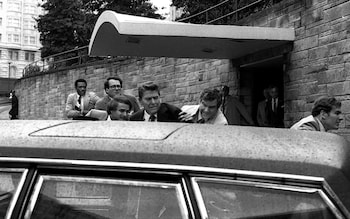 Ro<em></em>nald Reagan is shoved into a car by security following the attempt on his life in 1981