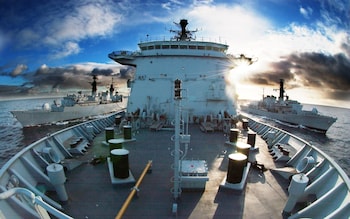 A naval supply ship refuelling a Royal Navy frigate (L)