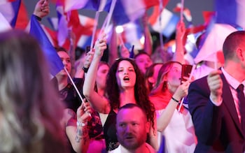 Supporters fly French flags during the results evening organised by the Natio<em></em>nal Rally party