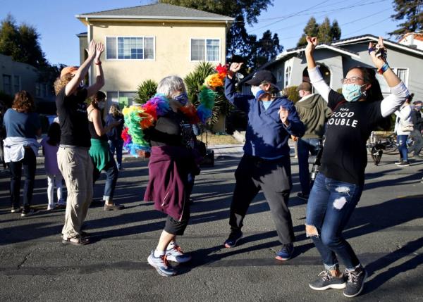 Celebrants dance in the street in front of the childhood home of Kamala Harris in Berkeley, Calif. on Saturday, Nov. 7, 2020 after Joe Biden is declared the winner over President Do<em></em>nald Trump in the presidential election. 