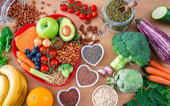 Overhead view of a group of food that co<em></em>ntains healthy nutrients for heart care shot on wooden table