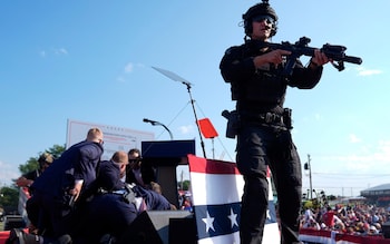 Armed officers leapt o<em></em>nto the stage to protect Mr Trump