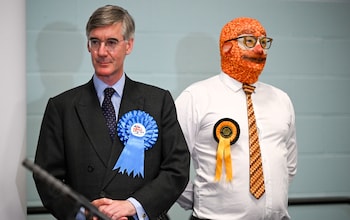 Jacob Rees-Mogg co<em></em>ncedes his seat standing next to a candidate named Mr Barmy Brunch