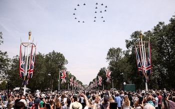 The public watch a fly-past of aircraft by the RAF from The Mall