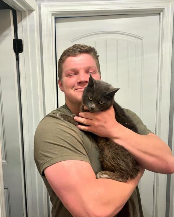 A man holding a cat.