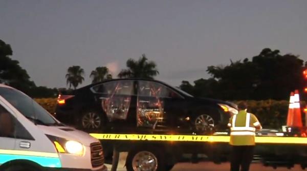 A tow truck carrying a car involved in a fatal shooting on the Florida Turnpike in Hollywood