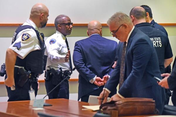 NYPD Sargeant Erik Duran with hands behind his back standing in Bronx Criminal Court. He is accused of murder of Eric Duprey.