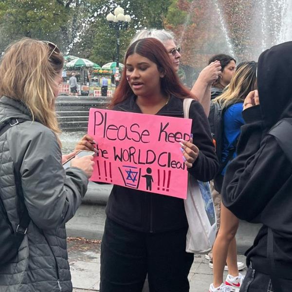 students are spotted holding up a Nazi era antisemitic signs wanting to rid the world of the Jews. 