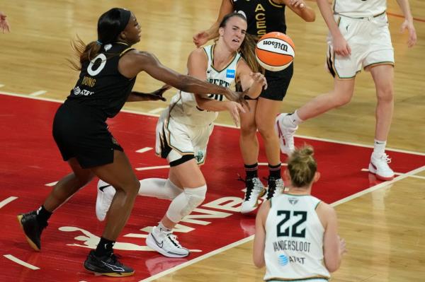 Liberty guard Sabrina Io<em></em>nescu (20) passes around Las Vegas Aces guard Jackie Young (0) during the first half in Game 1.