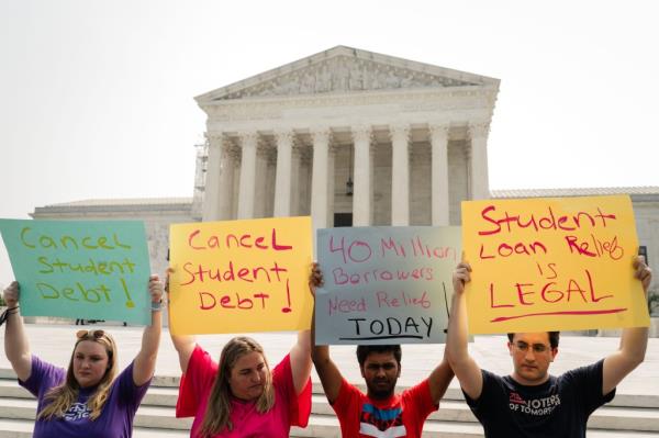 Student Debt relief advocates stand outside of the Supreme Court of the United States as they wait for the Supreme Court to release their opinion on wether or not to strike down President Biden's student debt relief program on Friday, June 30, 2023 in Washington, DC.