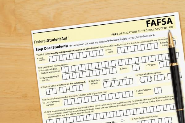 US federal Student Loan application form FAFSA on a wood desk