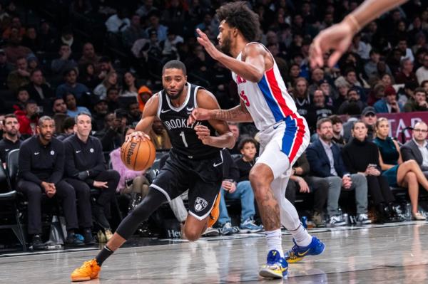 Mikal Bridges (1) of the Nets drives against the Pistons' Marvin Bagley III (35) on Dec. 23, 2023.