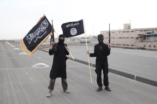 ISIS fighters holding guns and black flags