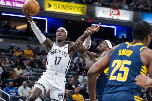 Dennis Schroder goes up for a layup as Pascal Siakam defends during the Nets' loss to the Pacers.