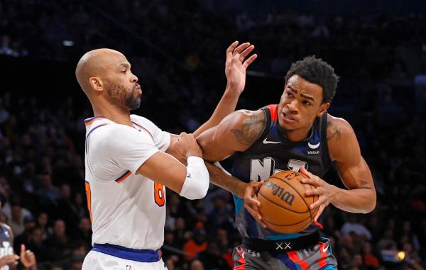 Nic Claxton drives to the basket as Taj Gibson #67 of the New York Knicks defends during the first half.